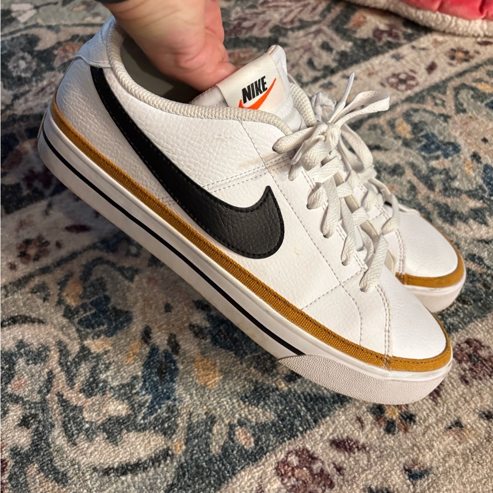 Nike White Sneakers with Black Swoosh and Gold Trim